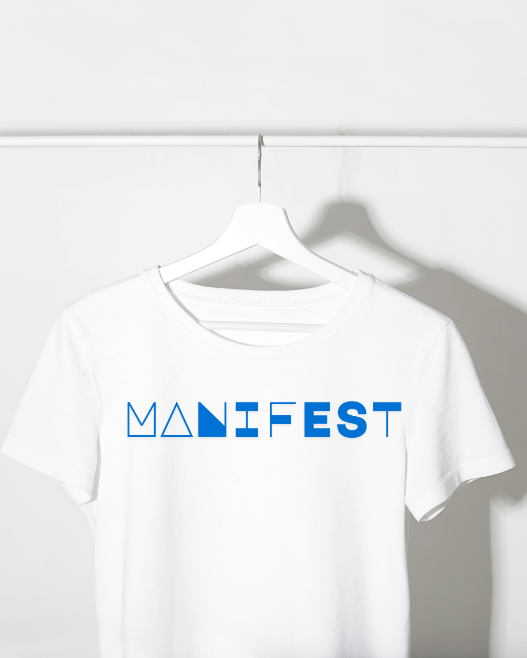 Baby White Tee – Bold “MANIFEST” Graphic Edition
